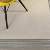 silla amarilla con patas negras sobre alfombra de vinilo keplan linea de kp alfombras a medida